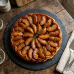 Tarte Tatin aux pommes caramélisées rosée dorée vue de dessus sur ardoise